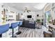 Open concept living room with breakfast bar features a cozy fireplace and sliding door access to a balcony at 7241 Indian Creek Ln # 203, Las Vegas, NV 89149