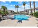 Community pool with surrounding lounge chairs and desert landscaping at 7241 Indian Creek Ln # 203, Las Vegas, NV 89149