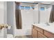 Clean bathroom featuring a combined shower and tub, complemented by a modern vanity at 7437 Treasure Chest St, Las Vegas, NV 89139