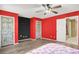 Bedroom with two entryways, ceiling fan, and wood-look flooring at 7437 Treasure Chest St, Las Vegas, NV 89139
