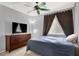 Cozy bedroom featuring neutral walls, a ceiling fan, and dresser for ample storage at 7437 Treasure Chest St, Las Vegas, NV 89139