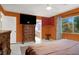 A cozy primary bedroom with a ceiling fan, complemented by a large window at 7437 Treasure Chest St, Las Vegas, NV 89139