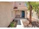 Charming front porch with blue door, bench, and tiled roof at 7437 Treasure Chest St, Las Vegas, NV 89139