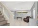 Open concept living area with tile floors, stairs, and neutral paint at 7437 Treasure Chest St, Las Vegas, NV 89139