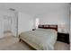 Bedroom featuring a queen bed, bedside tables, and a door leading to another room at 7707 W Diablo Dr, Las Vegas, NV 89113