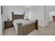 Bedroom features wood bed frame, two side tables with lamps, and a neutral carpet and paint at 7707 W Diablo Dr, Las Vegas, NV 89113