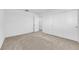 Empty bedroom features neutral carpet and paint, sliding door closet, and an open door to another room at 7707 W Diablo Dr, Las Vegas, NV 89113