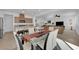 Open-concept kitchen and dining room features modern table and stainless steel appliances at 7707 W Diablo Dr, Las Vegas, NV 89113