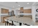 Kitchen features a granite island with barstool seating, stainless steel appliances, and wood cabinets at 7707 W Diablo Dr, Las Vegas, NV 89113
