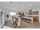 Open-concept kitchen features a granite island with barstool seating and stainless steel appliances at 7707 W Diablo Dr, Las Vegas, NV 89113
