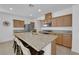 Kitchen features a granite island with barstool seating, stainless steel appliances, and wood cabinets at 7707 W Diablo Dr, Las Vegas, NV 89113