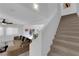 Open-concept living room showing a staircase, neutral colored walls, carpet, and plenty of natural light at 7707 W Diablo Dr, Las Vegas, NV 89113