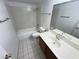 Bright bathroom featuring a combined shower and tub, white tile, and a vanity with a sink at 7948 Calico Vista Blvd # 101, Las Vegas, NV 89128