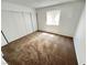 Cozy bedroom with a neutral color palette, carpet floors, and natural light from the window at 7948 Calico Vista Blvd # 101, Las Vegas, NV 89128