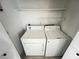 Functional laundry room with washer, dryer, and overhead shelving at 7948 Calico Vista Blvd # 101, Las Vegas, NV 89128