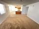 Open-concept living area with carpet, flowing into the kitchen with island at 7948 Calico Vista Blvd # 101, Las Vegas, NV 89128