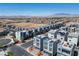 Aerial view of a neighborhood featuring modern townhomes with rooftop balconies and mountain views at 8175 Caldera Creek St, Las Vegas, NV 89113