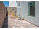 Brick paver back patio surrounded by a block wall and minimalist desert landscaping at 8175 Caldera Creek St, Las Vegas, NV 89113