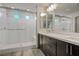Modern bathroom with a glass-enclosed shower, double sink vanity, and neutral color scheme at 8175 Caldera Creek St, Las Vegas, NV 89113