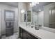 Modern bathroom showcasing a large mirror, dark vanity with sink, and stylish decor at 8175 Caldera Creek St, Las Vegas, NV 89113