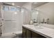 Bright bathroom featuring a walk-in shower with marble surround, dark vanity, and modern sink at 8175 Caldera Creek St, Las Vegas, NV 89113