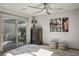 Comfortable bedroom featuring a sliding glass door to patio, ceiling fan, and relaxing decor at 8175 Caldera Creek St, Las Vegas, NV 89113
