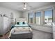 Cozy bedroom featuring a bed with floral bedding, plantation shutters, and ceiling fan at 8175 Caldera Creek St, Las Vegas, NV 89113