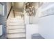 Elegant entryway with a staircase, stylish decor with decorative flowers, and light, neutral color palette at 8175 Caldera Creek St, Las Vegas, NV 89113