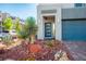 Close-up of the front entrance featuring desert landscaping and a modern glass-paneled door at 8175 Caldera Creek St, Las Vegas, NV 89113