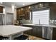 Kitchen features sleek cabinets, stainless appliances, a large island, and modern pendant lighting at 8175 Caldera Creek St, Las Vegas, NV 89113