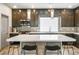 Bright kitchen featuring modern cabinets, stainless steel appliances, a subway tile backsplash, and an island with seating at 8175 Caldera Creek St, Las Vegas, NV 89113