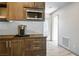 Convenient kitchenette showcasing wooden cabinets, modern microwave, and counter space with a coffee maker at 8175 Caldera Creek St, Las Vegas, NV 89113