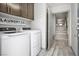Functional laundry room equipped with modern washer and dryer units and cabinet storage at 8175 Caldera Creek St, Las Vegas, NV 89113