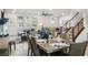 Open-concept living space with wood floors, modern furnishings, a staircase, and many windows for natural light at 8175 Caldera Creek St, Las Vegas, NV 89113