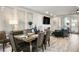 Open concept dining and living space featuring wood floors and modern furniture at 8175 Caldera Creek St, Las Vegas, NV 89113