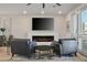 Cozy living room features a modern fireplace, a large flat-screen television, and plenty of natural light at 8175 Caldera Creek St, Las Vegas, NV 89113