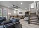 Bright living room featuring a modern ceiling fan, comfortable seating, and stylish decor on light wood floors at 8175 Caldera Creek St, Las Vegas, NV 89113