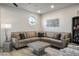 Bright living room showcasing a modern sectional sofa, unique lighting, and artistic metal wall decor at 8175 Caldera Creek St, Las Vegas, NV 89113