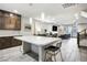 Open concept living space with a kitchen island extending to the dining and living areas at 8175 Caldera Creek St, Las Vegas, NV 89113
