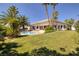 This backyard features lush landscaping, a pool, and a well-manicured lawn at 8290 Gagnier Blvd, Las Vegas, NV 89113