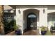 Elegant front entrance featuring a beautifully crafted door and inviting landscaping at 8290 Gagnier Blvd, Las Vegas, NV 89113