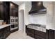 Kitchen detail showcasing stainless steel appliances, dark cabinets, and modern backsplash at 8290 Gagnier Blvd, Las Vegas, NV 89113
