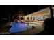 Private backyard oasis with custom pool and spa, lush landscaping, desert landscaping and mature palm trees at 8290 Gagnier Blvd, Las Vegas, NV 89113