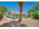 This home features a covered patio and desert landscaping in the backyard at 8813 Sundial Dr, Las Vegas, NV 89134