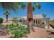 The home's backyard includes desert landscaping with artificial turf and a covered patio area at 8813 Sundial Dr, Las Vegas, NV 89134