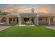 A covered outdoor patio with ample seating, manicured landscaping, and backyard make this home perfect for entertaining at 8813 Sundial Dr, Las Vegas, NV 89134