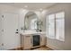 Stylish bar area features a built-in wine fridge, modern cabinetry and countertop, plus a chic arch-shaped mirror at 8813 Sundial Dr, Las Vegas, NV 89134