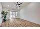 Bright bedroom with wood-look floors, ceiling fan, and sliding glass doors leading to outdoor space at 8813 Sundial Dr, Las Vegas, NV 89134