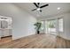 Cozy bedroom features wood-look floors, bright windows, and an adjacent bathroom at 8813 Sundial Dr, Las Vegas, NV 89134