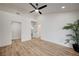 Light-filled bedroom with modern ceiling fan, wood-look floors, and two doors in the room at 8813 Sundial Dr, Las Vegas, NV 89134